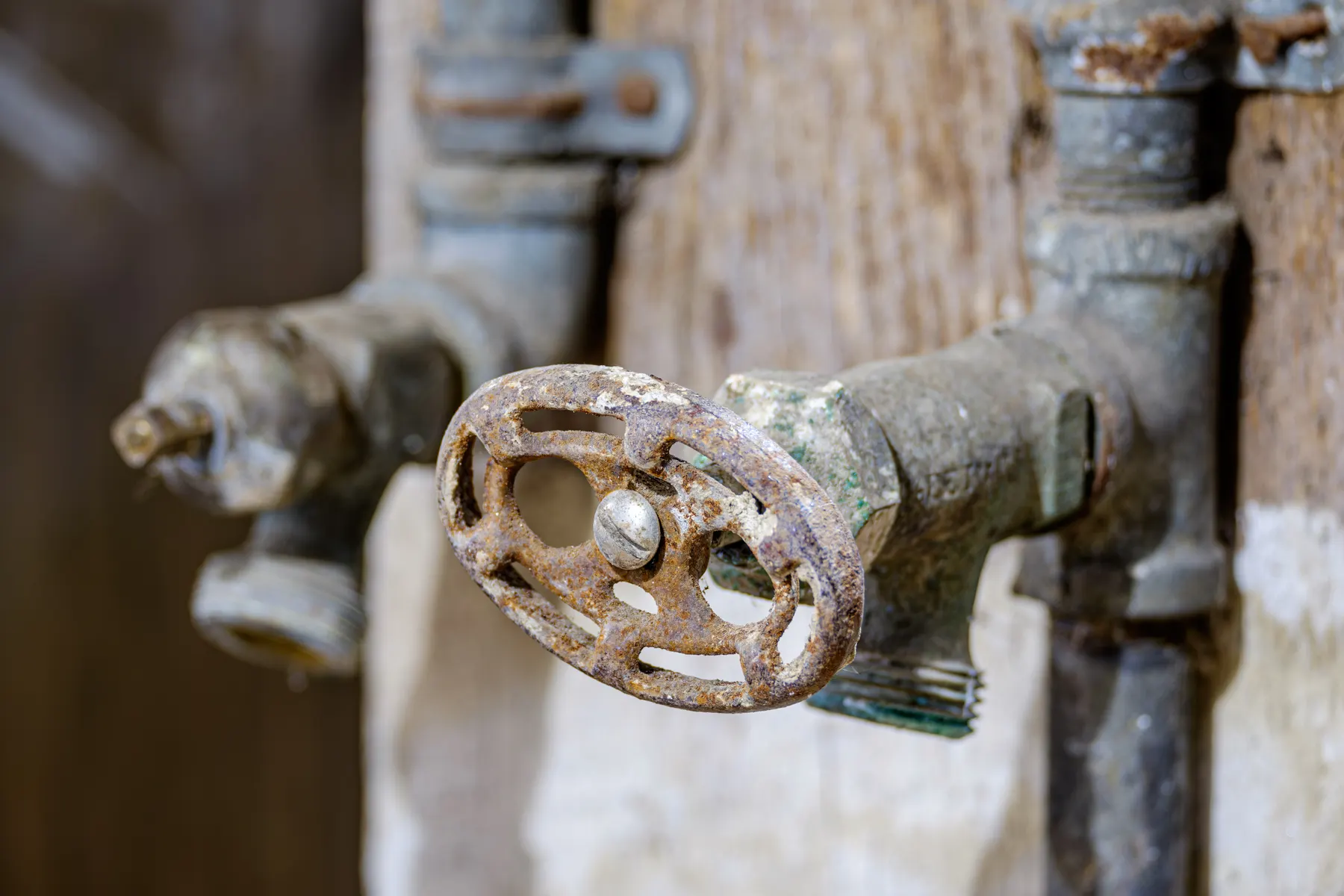 Corroded outdoor shut off valve on old galvanized pipe